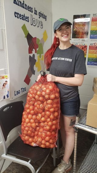 Food Pantry Volunteer with a large sack of potatoes