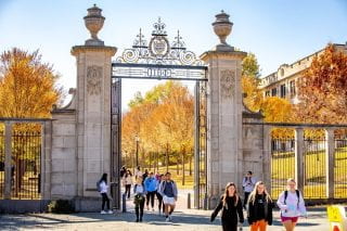 Students walking through the gate on Maple Street