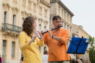 Nikola Radan and Chelsea Hodge play flute on the Honors Passport Pilgrimage course. Photo by Russell Cothren.